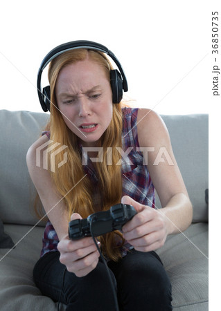 Woman playing video game against white background 36850735