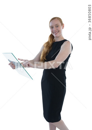Female executive using glass digital tablet Female executive using glass digital tablet 36850803