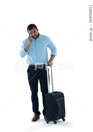 Male executive with luggage talking on mobile phone 36850851