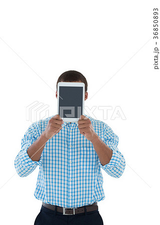 Male executive hiding his face with digital tablet 36850893