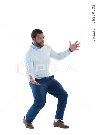 Male executive pretending to hold an invisible object Male executive pretending to hold an invisible object 36850903