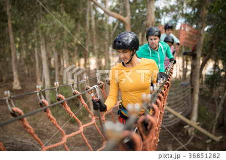 Friends walking on rope bridge 36851282