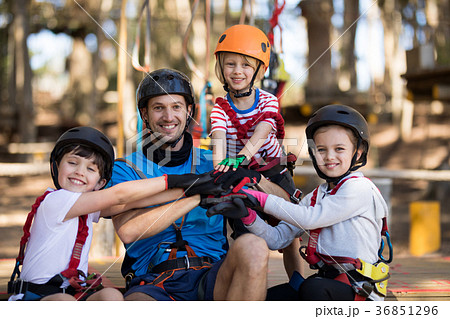 Instructor and kids forming hand stack in park Instructor and kids forming hand stack in park 36851296