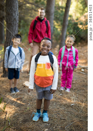 Kids and teacher standing in park 36851403