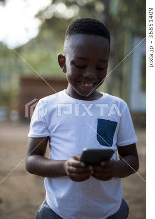 Close-up of cute boy using mobile phone 36851409