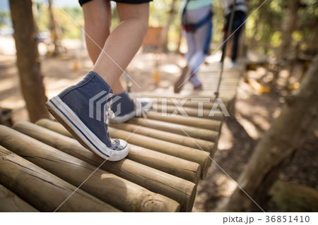 Low section of kid crossing wooden bridge 36851410