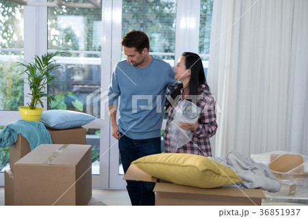 Couple standing together at their new home Couple standing together at their new home 36851937