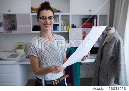 Fashion designer holding a document 36851938