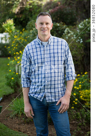 Smiling man standing in garden 36852080