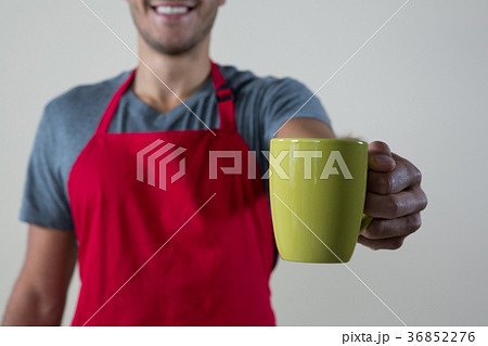 Waiter offering a cup of coffee Waiter offering a cup of coffee 36852276