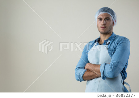 Confident waiter standing with his hands crossed Confident waiter standing with his hands crossed 36852277