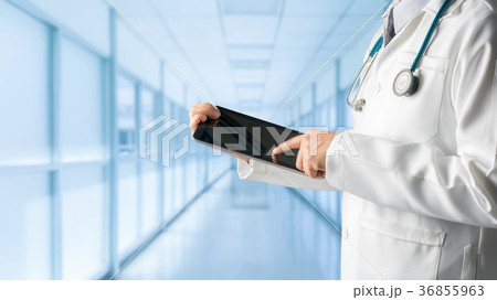Male doctor using tablet computer. Male doctor using tablet computer. 36855963