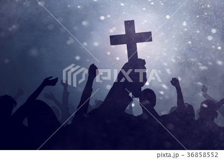 Silhouette hand holding christian cross Silhouette hand holding christian cross 36858552