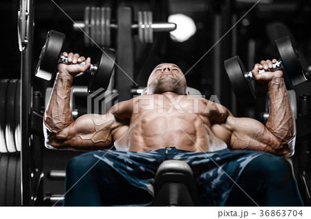 Brutal strong bodybuilder athletic men pumping up muscles with d 36863704