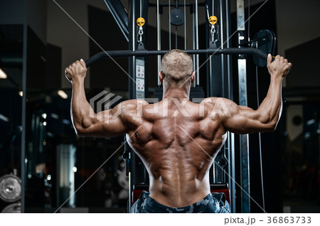 Brutal strong bodybuilder athletic men pumping up muscles with d 36863733