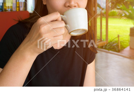 female hand holding a cup of coffee 36864141