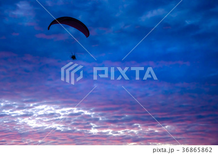 Motorized paraglider flying up high on the sky 36865862