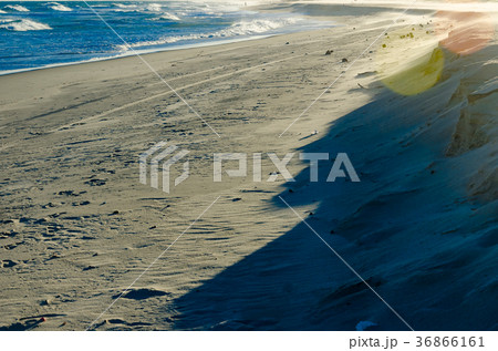 View of a sunset on a white sand beach View of a sunset on a white sand beach 36866161