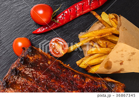 grilled ribs with fries 36867345