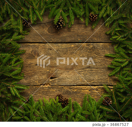 Christmas tree branches with cones on wood Christmas tree branches with cones on wood 36867527
