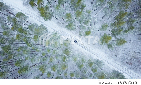 Aerial view on car driving through winter road Aerial view on car driving through winter road 36867538