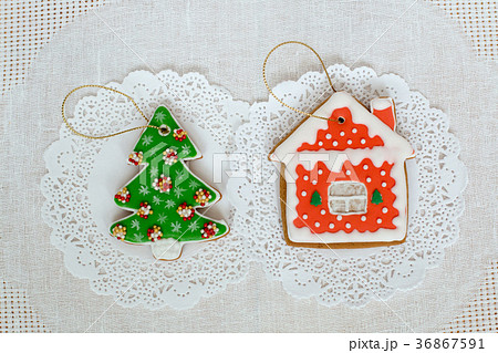 Two gingerbread cookies in the shape of the 36867591