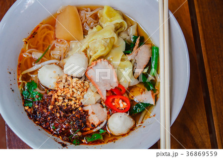 Noodle and dumpling with barbecued red pork. 36869559