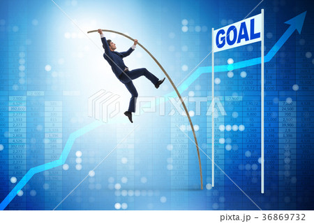 Businessman pole vaulting towards his goal in 36869732
