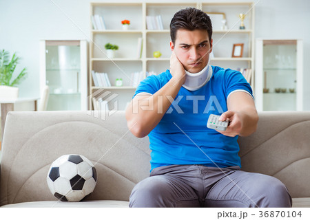 Man with neck injury watching football soccer at Man with neck injury watching football soccer at 36870104