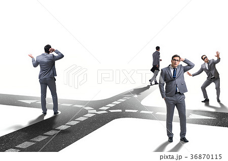 Young businessman at crossroads in uncertainty 36870115