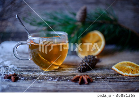 tea glass Cup on a wooden table with pine branches tea glass Cup on a wooden table with pine branches 36881268