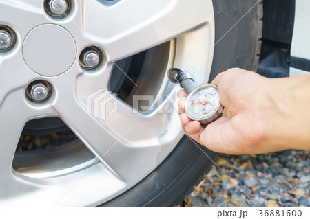 mechanic hands checking tire pressure using gauge mechanic hands checking tire pressure using gauge 36881600
