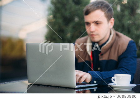 The young manager working on a laptop in the park 36883980