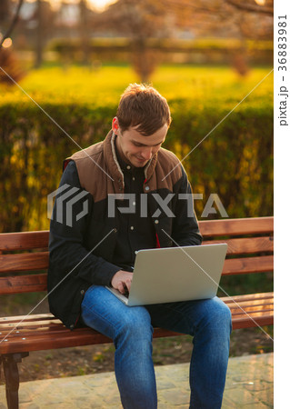 The young manager working on a laptop in the park 36883981