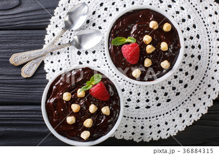 Sweet chocolate pudding decorated with hazelnuts Sweet chocolate pudding decorated with hazelnuts 36884315