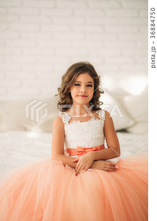 Little beautiful girl with brown hair in a Peach 36884750