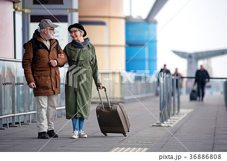 Pleasant senior couple is situating near airport 36886808