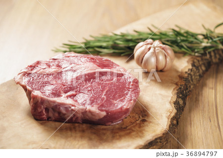 fresh raw rib eye steak on wood board on kitchen 36894797