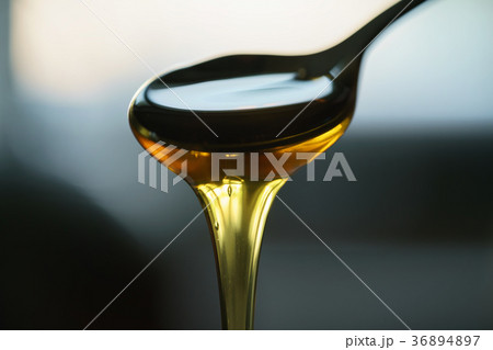 organic honey dripping from spoon 36894897