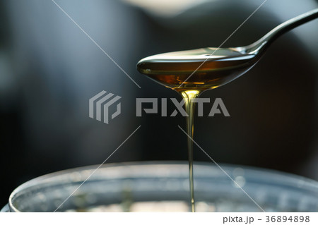 organic honey dripping from spoon 36894898