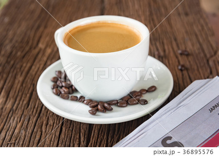 A cup of coffee and a newspaper A cup of coffee and a newspaper 36895576