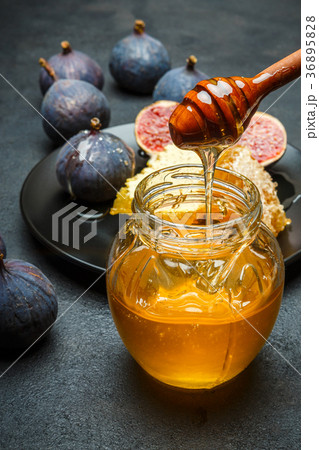 Figs with honey on in the plate on dark concrete 36895828