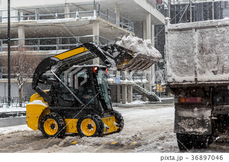 Machine remove snow from a city street Machine remove snow from a city street 36897046