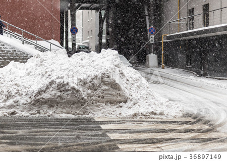 Huge heap of dirty snow and ice on a city street Huge heap of dirty snow and ice on a city street 36897149
