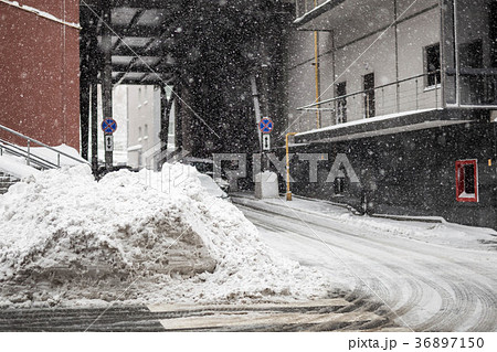 Huge heap of dirty snow and ice on a city street 36897150