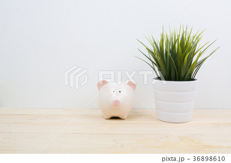 a pink piggy bank on desk wood 36898610
