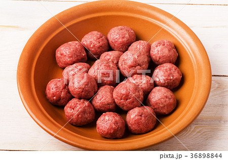 Raw meatballs in plate 36898844