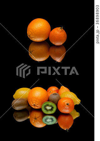orange and other fruits on a black background 36898903