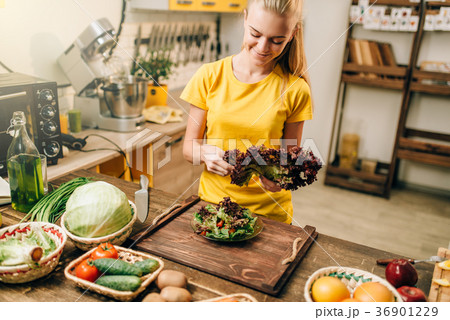 Happy woman holding salad, cooking healthy food 36901229