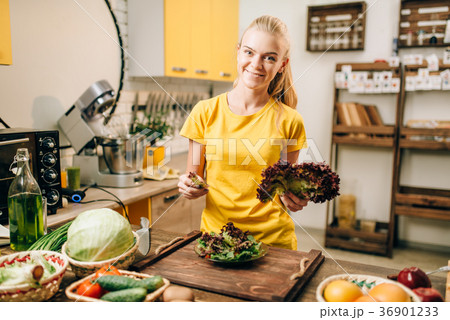 Happy woman holding salad, cooking healthy food Happy woman holding salad, cooking healthy food 36901233